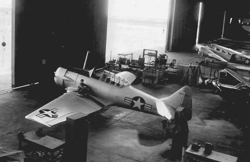 One of the Base\'s two SNJ\'s and the SN Baker as seen from the Main Hangar\'s second floor balcony. The Motor Mec on the wing is Silvers..jpg